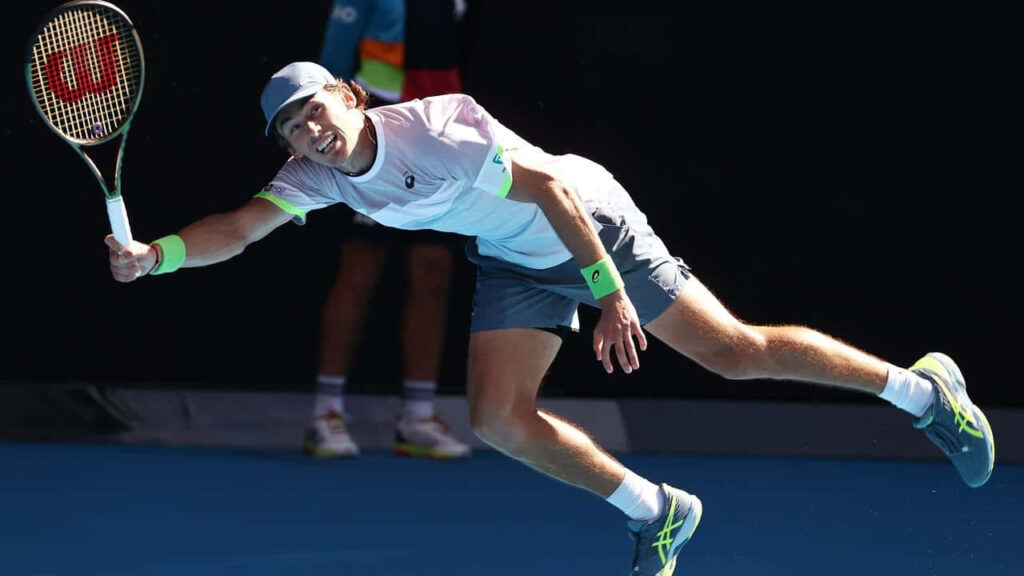 Alex de Minaur stretching for forehand during intense tennis match showing athletic focus Wallpaper