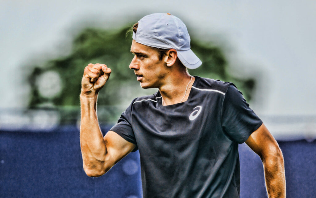 Alex de Minaur tennis player celebrating with fist pump wearing athletic gear and backwards cap wallpaper