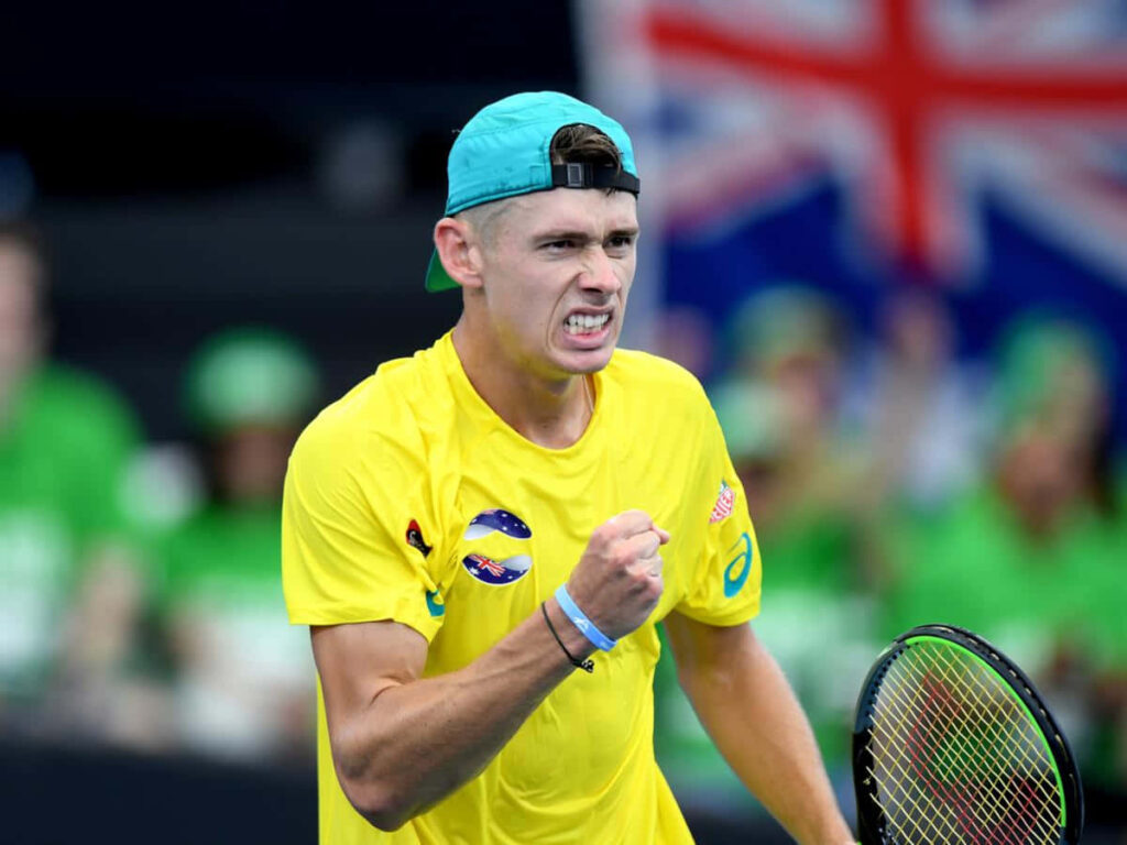 Alex de Minaur celebrating victory on court showing intense determination Australian tennis star Wallpaper