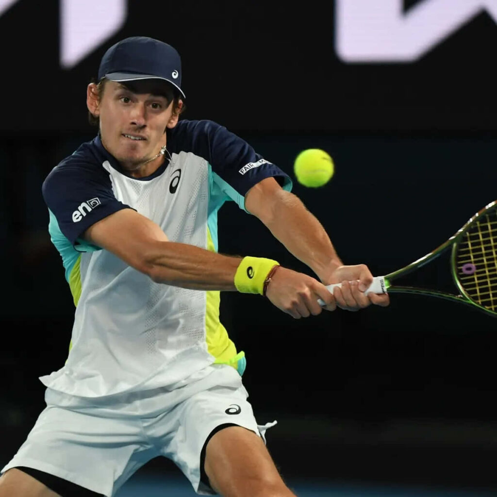 Alex de Minaur intense tennis return action during professional match dynamic court wallpaper