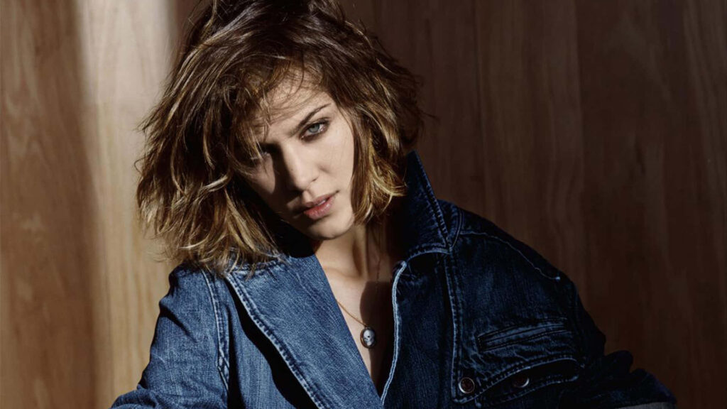 Alexa Chung wearing stylish denim jacket with cool vibe wooden background wallpaper