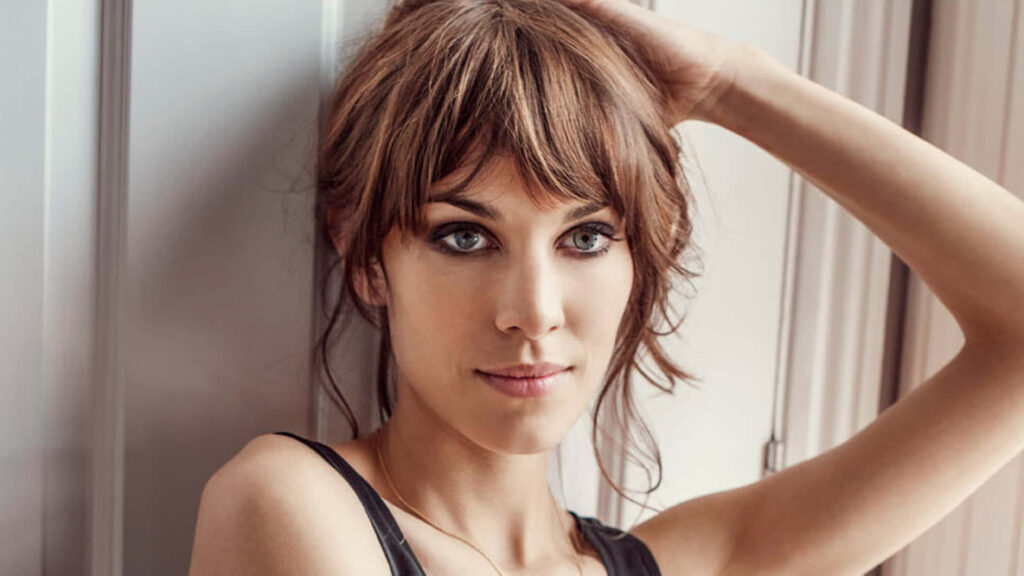 Alexa Chung stylish portrait showcasing confident fashion icon with chic wallpaper background