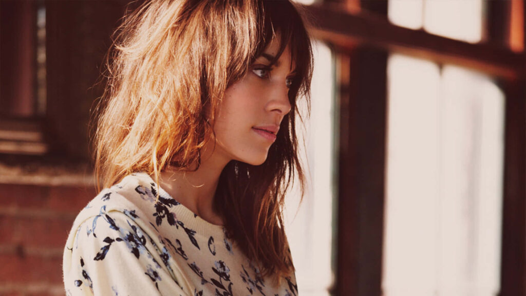 Alexa Chung soft-lit profile with tousled hair floral sweater stylish calm wallpaper background