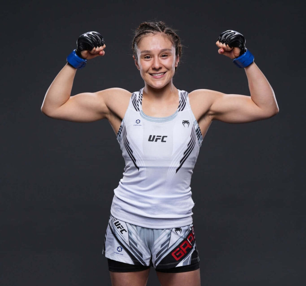 Alexa Grasso in UFC fight gear flexing muscles showing strength and determination in MMA Wallpaper