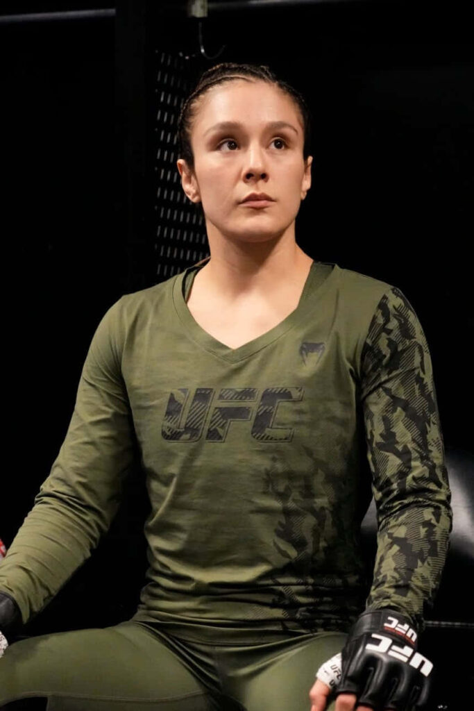 Alexa Grasso wearing green UFC training outfit sitting confidently backstage before fight wallpaper