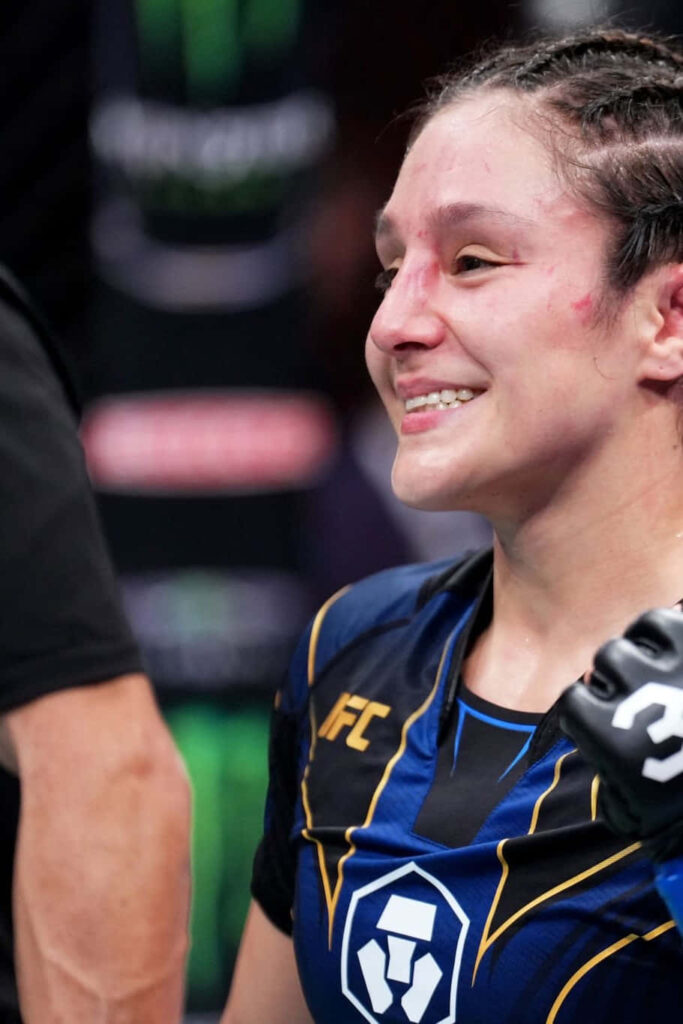 Alexa Grasso UFC fighter celebrates victory in octagon wearing fight gear and battle marks wallpaper