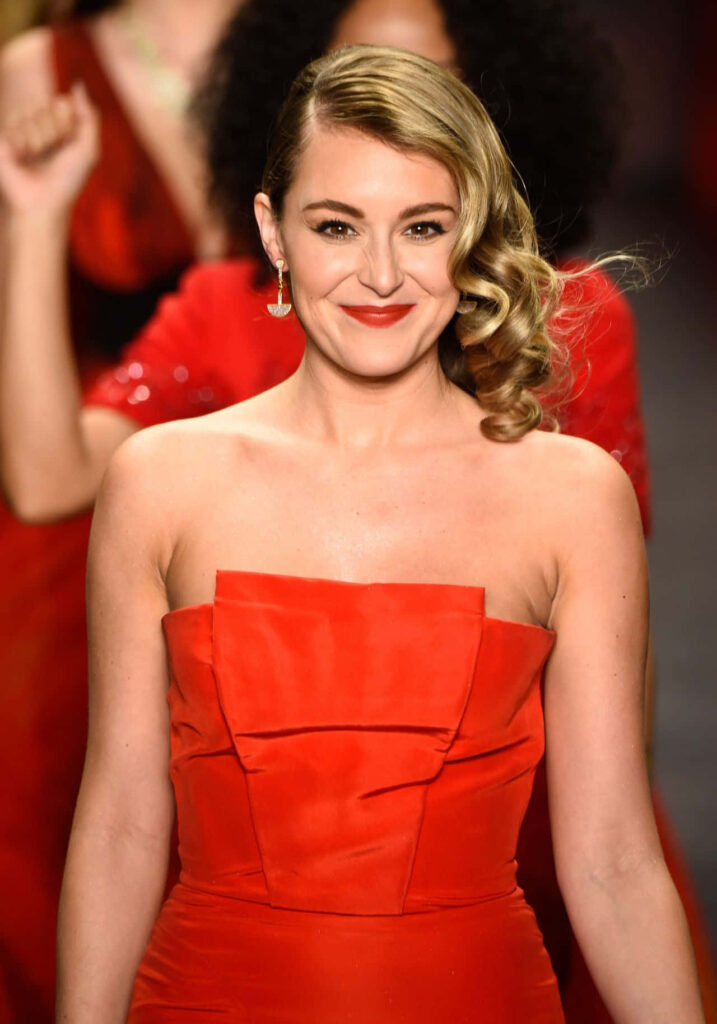 Alexa PenaVega in red strapless dress with curled hair smiling vibrant wallpaper background