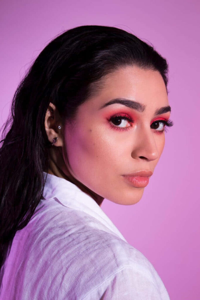 Striking portrait of Alexa Rose Steele with vibrant pink makeup on soft pink backdrop wallpaper