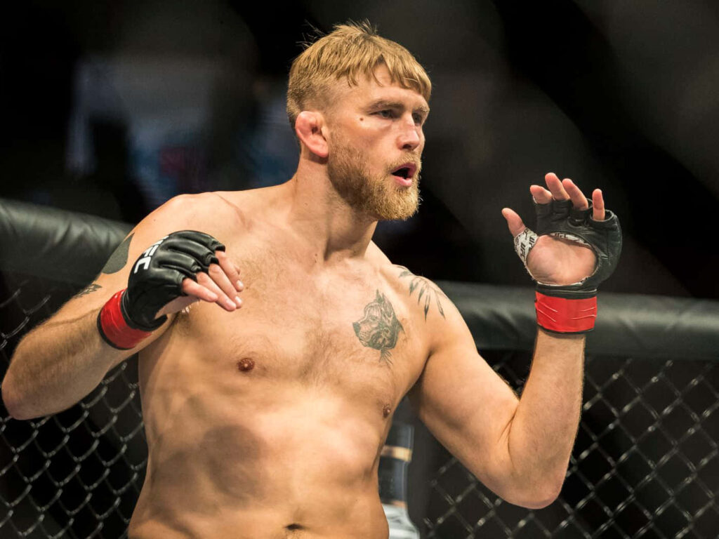 Alexander Gustafsson MMA fighter focused and intense inside the mixed martial arts cage wallpaper background