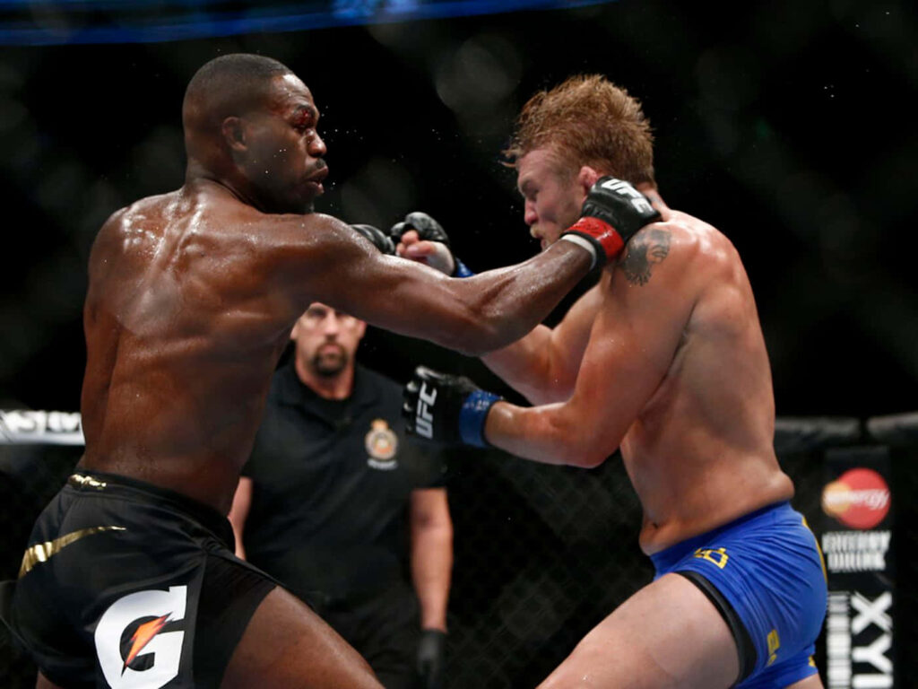 Alexander Gustafsson and Jon Jones exchanging powerful strikes in intense UFC octagon fight wallpaper