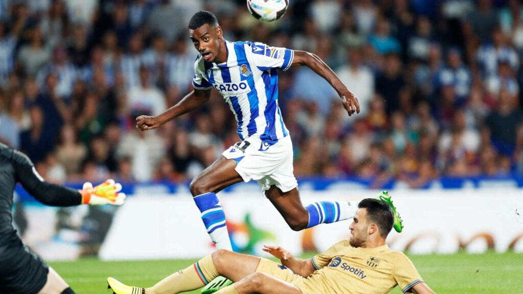 Alexander Isak mid-air leap over opponent showing agility and skill in intense football match wallpaper