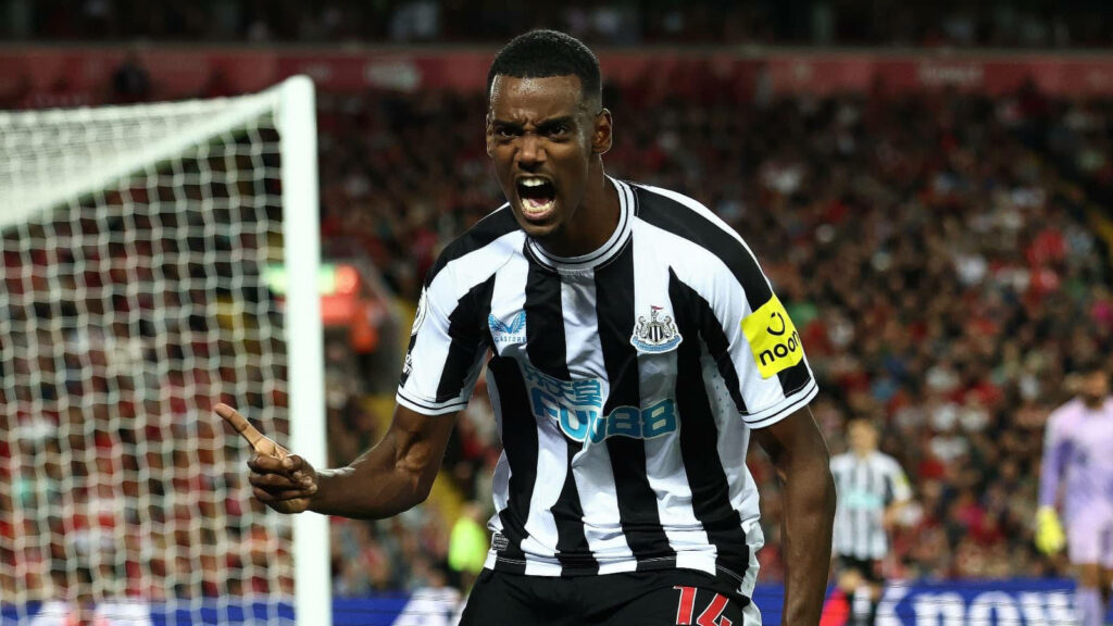 Alexander Isak yelling passionately on the field in Newcastle United kit wallpaper background