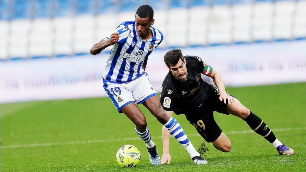 Alexander Isak dribbling past defender in intense football match showing agility and control wallpaper