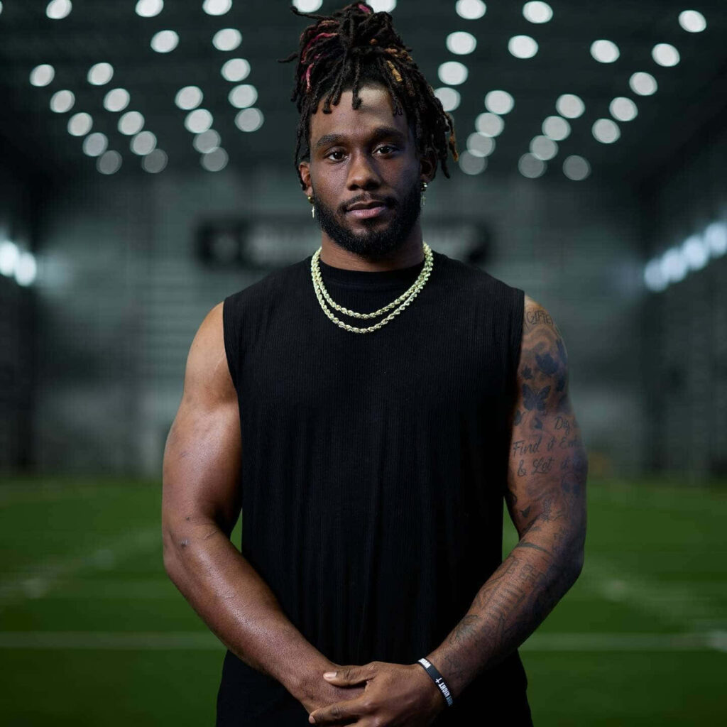 Alexander Mattison confident portrait in stadium showcasing athletic presence and focus Wallpaper