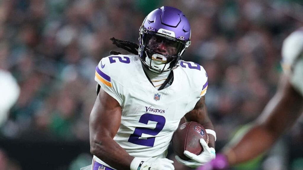 Alexander Mattison Minnesota Vikings running back charging field white purple uniform dynamic action Wallpaper
