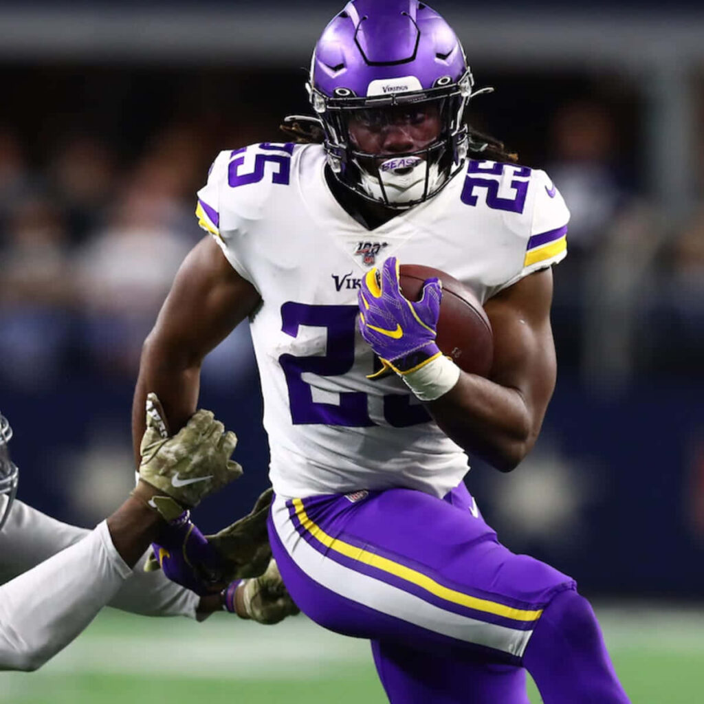 Alexander Mattison Minnesota Vikings running football strong through defenders action wallpaper