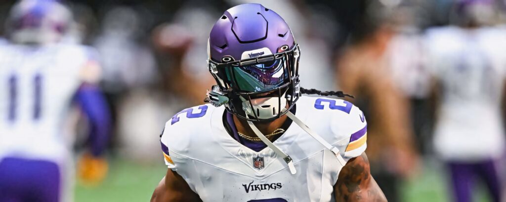 Alexander Mattison focused in Minnesota Vikings uniform and helmet dynamic football wallpaper background