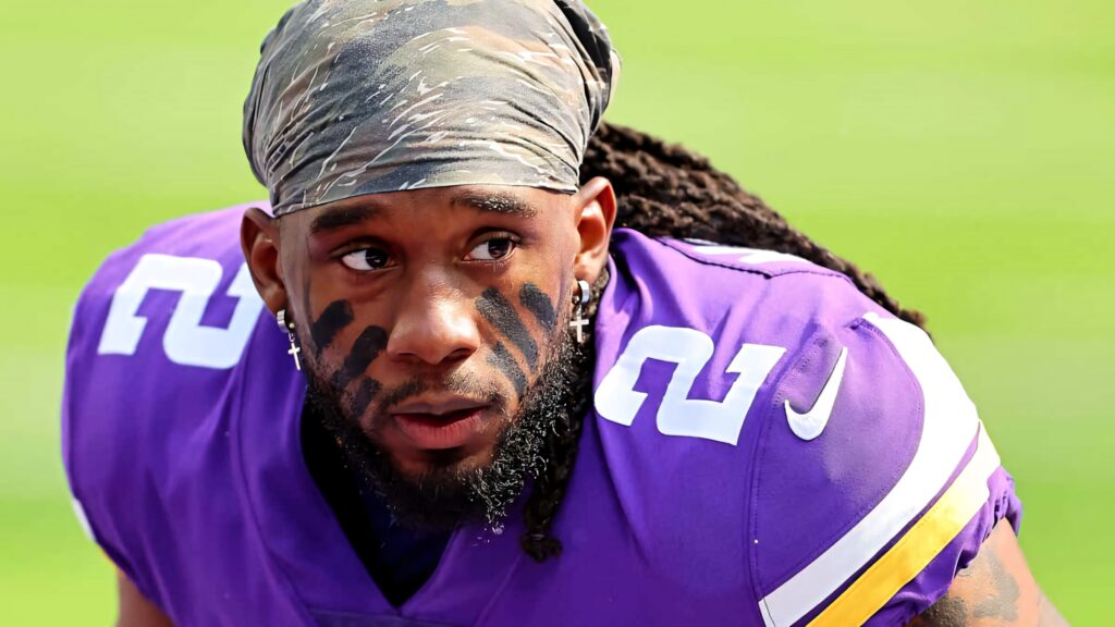 Alexander Mattison in Minnesota Vikings uniform showing intense focus on the football field wallpaper