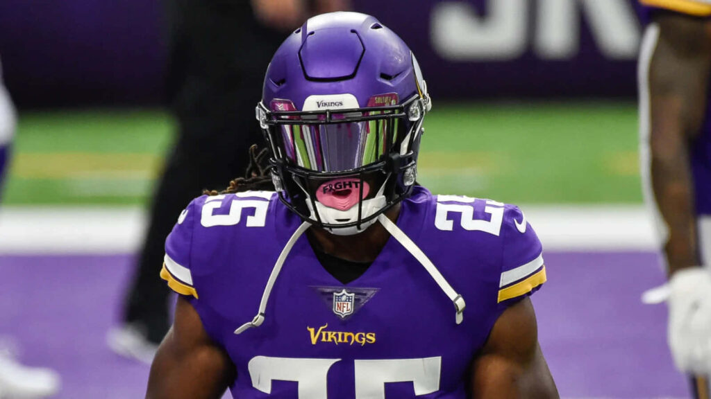 Alexander Mattison Minnesota Vikings in full uniform focused during game preparation wallpaper