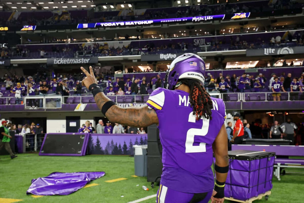 Alexander Mattison Minnesota Vikings peace sign vibrant football stadium energetic wallpaper