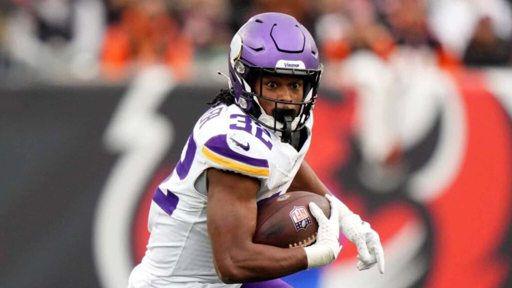Alexander Mattison Minnesota Vikings running back carries football with focus during game wallpaper