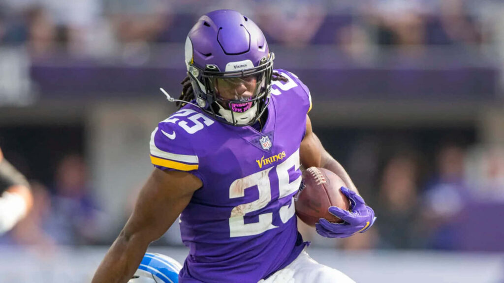 Alexander Mattison running back in full stride powering forward with football Minnesota Vikings Wallpaper