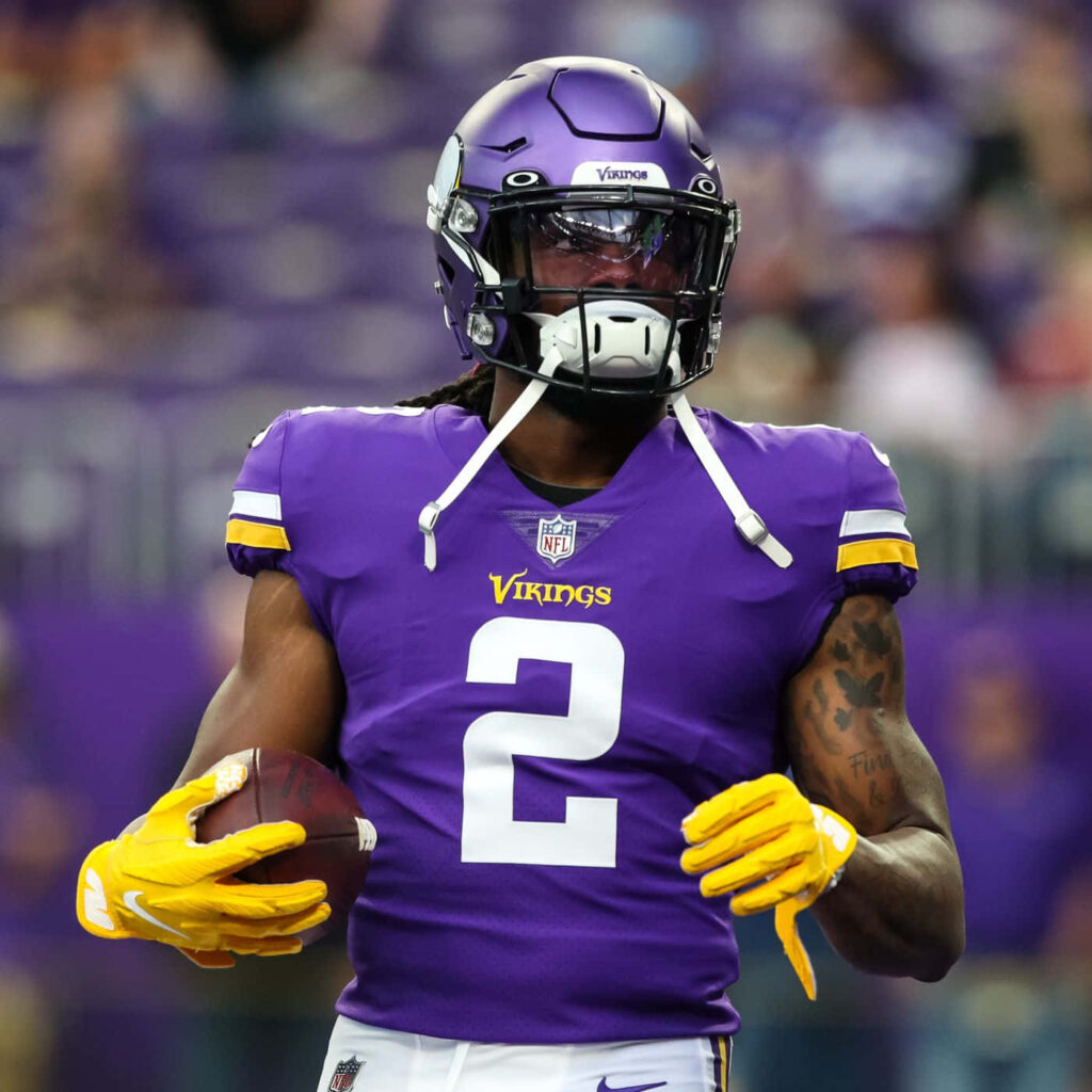 Alexander Mattison Minnesota Vikings running back in uniform holding football on field wallpaper