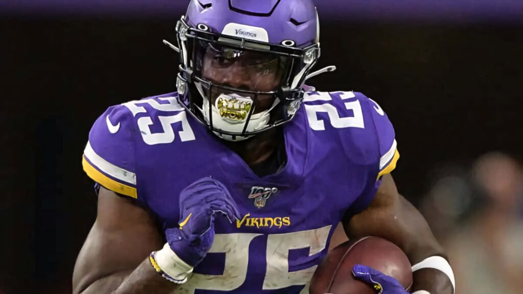 Alexander Mattison Minnesota Vikings running back in purple and gold uniform charging forward Wallpaper