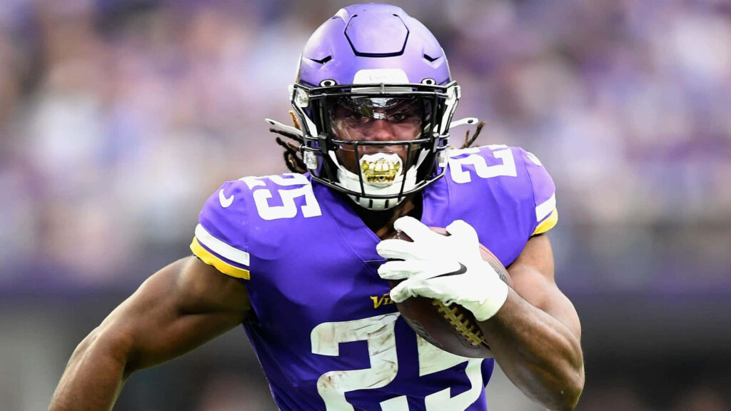 Alexander Mattison in Minnesota Vikings uniform powering down the field NFL running back action Wallpaper