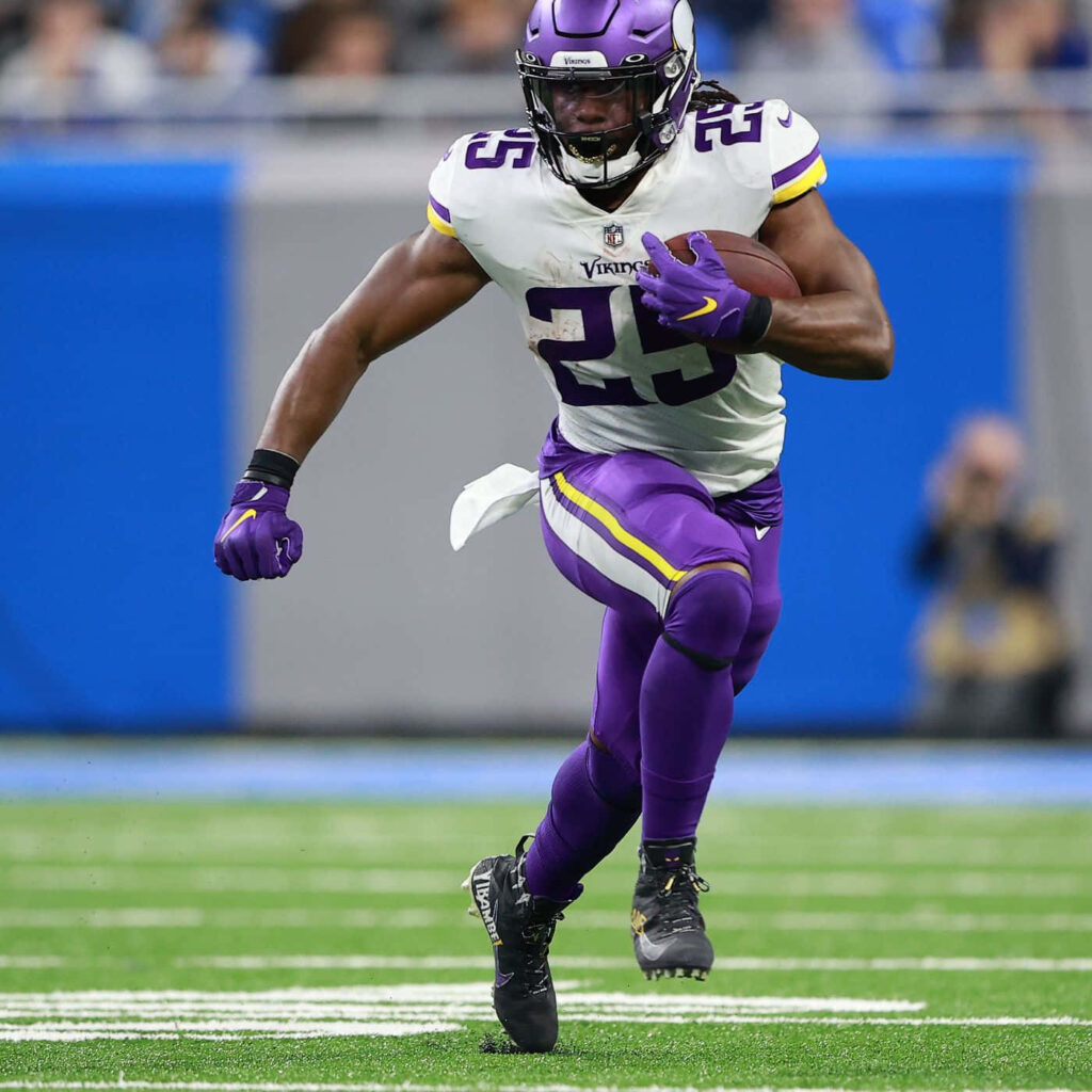 Alexander Mattison Minnesota Vikings running back powering down the field in dynamic action wallpaper