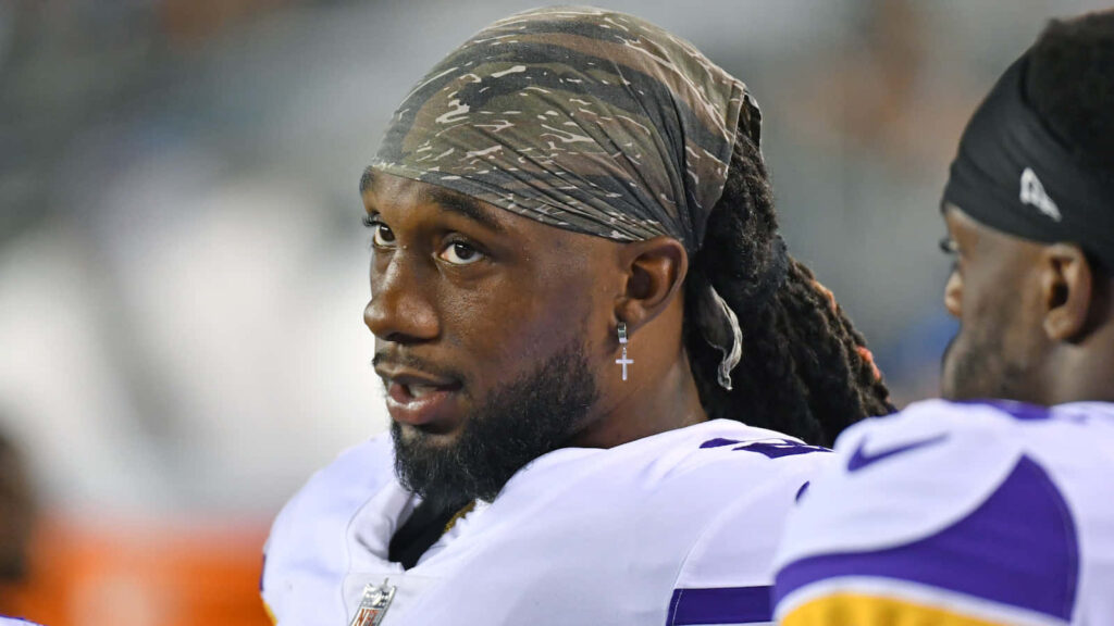 Alexander Mattison intense sideline focus NFL wallpaper background showcasing determination