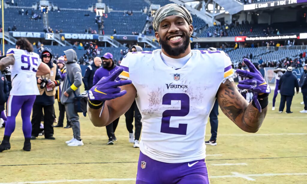 Alexander Mattison celebrates in Vikings uniform on field dynamic football wallpaper background