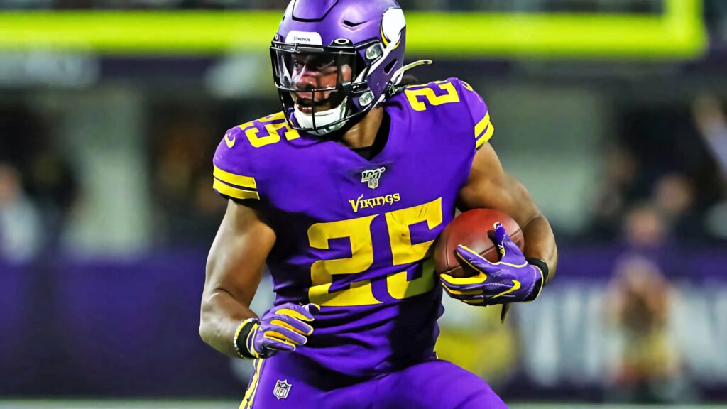 Alexander Mattison Vikings running back charges through field showing power and determination Wallpaper