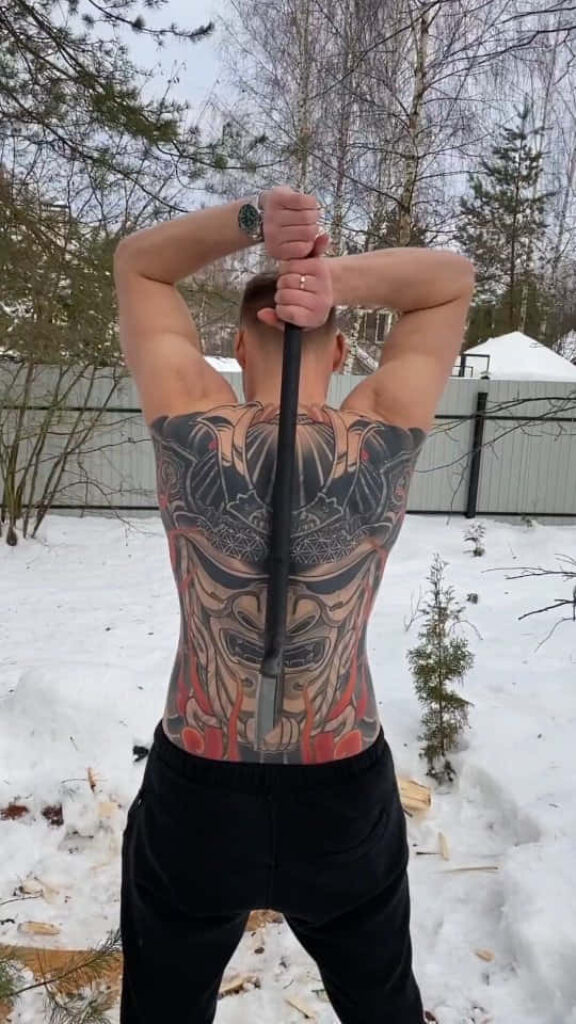 Alexander Volkov displaying detailed full back tattoo outdoors in snowy winter setting wallpaper