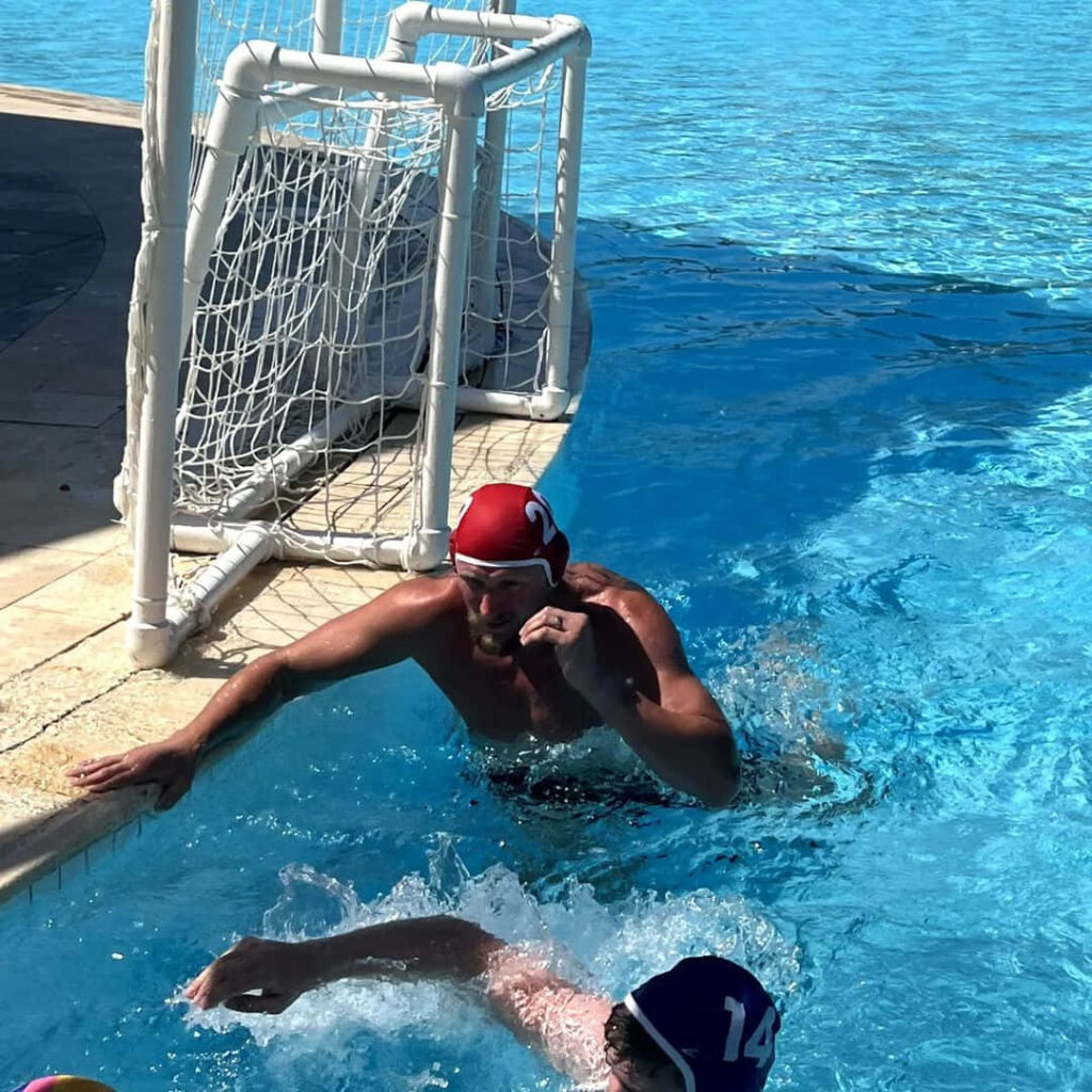 Alexander Volkov swimming powerfully near goal showing intense focus and athleticism wallpaper