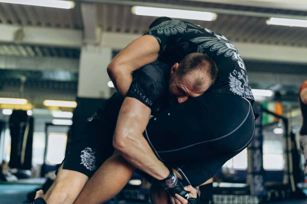 Alexander Volkov powerful tackle mid-action intense training session dynamic wallpaper background