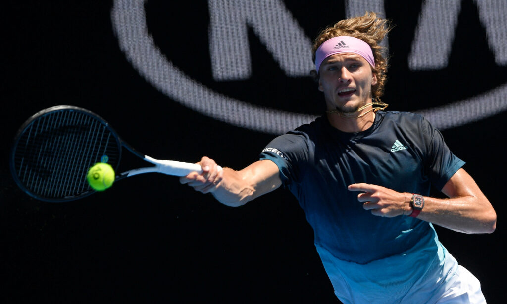 Alexander Zverev intense focus chasing tennis ball displaying athleticism and determination on court Wallpaper