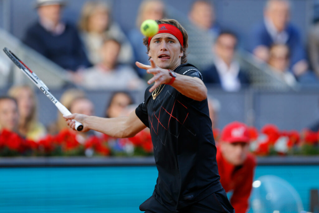 Alexander Zverev focused serving in professional tennis match showcasing athletic form and determination Wallpaper