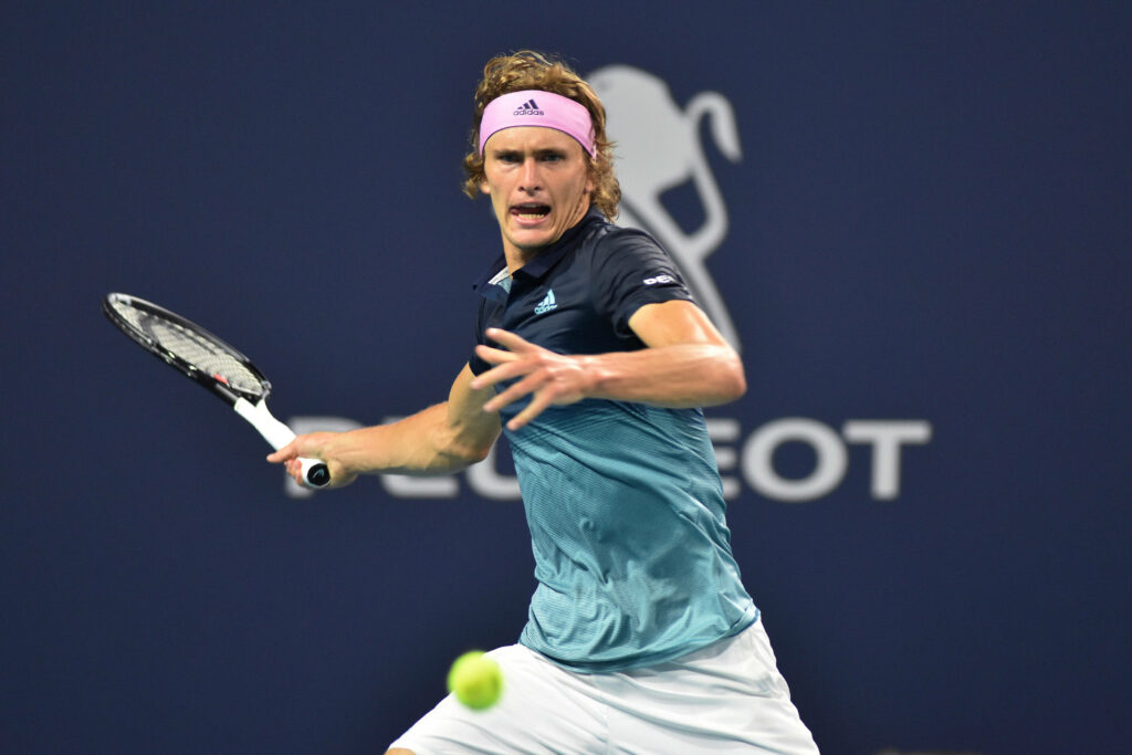 Alexander Zverev focused returning shot mid tennis match action on court wallpaper background