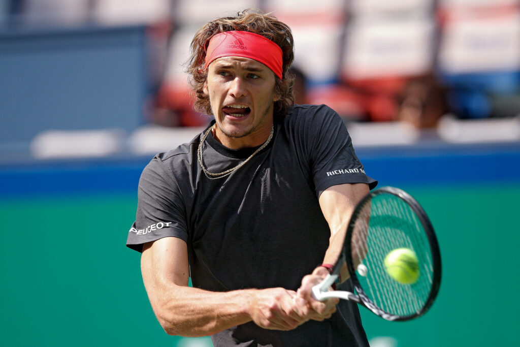 Alexander Zverev focused tennis player returning shot displaying athleticism and determination Wallpaper