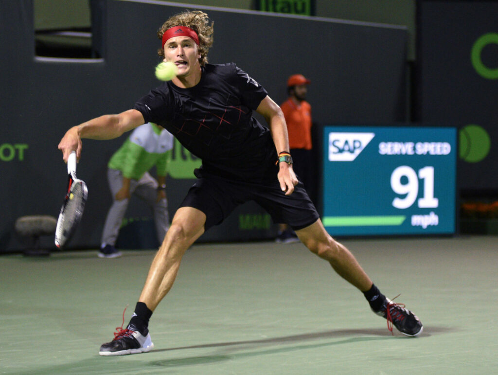 Alexander Zverev hitting a powerful forehand during intense tennis training session on court Wallpaper