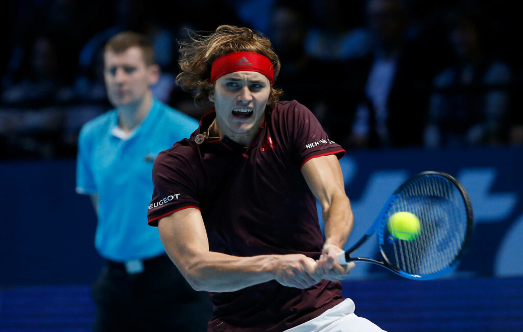 Alexander Zverev powerful two-handed tennis smash showing focus and athleticism on court Wallpaper