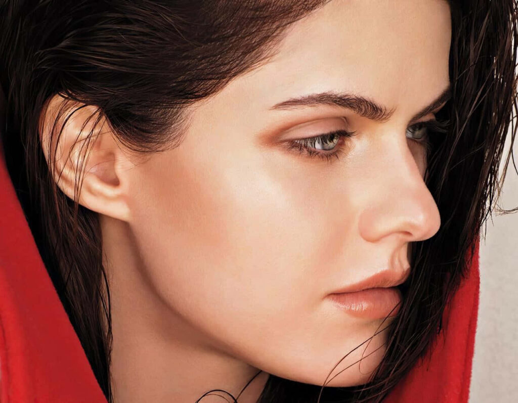 Alexandra Daddario side profile wallpaper showcasing flawless skin and intense expression background