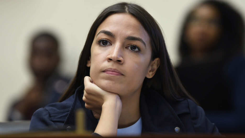 Alexandria Ocasio-Cortez focused and determined with assertive expression wallpaper background