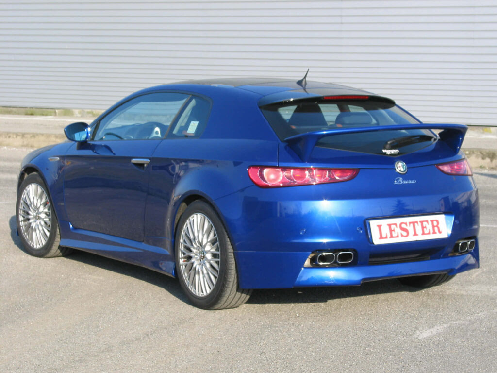 Alfa Romeo Brera in vibrant blue with sporty design against industrial open area background wallpaper