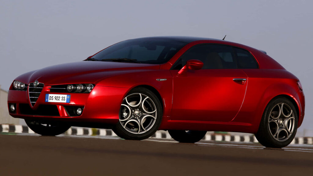 Alfa Romeo Brera red sports car with sleek design in scenic outdoor wallpaper background