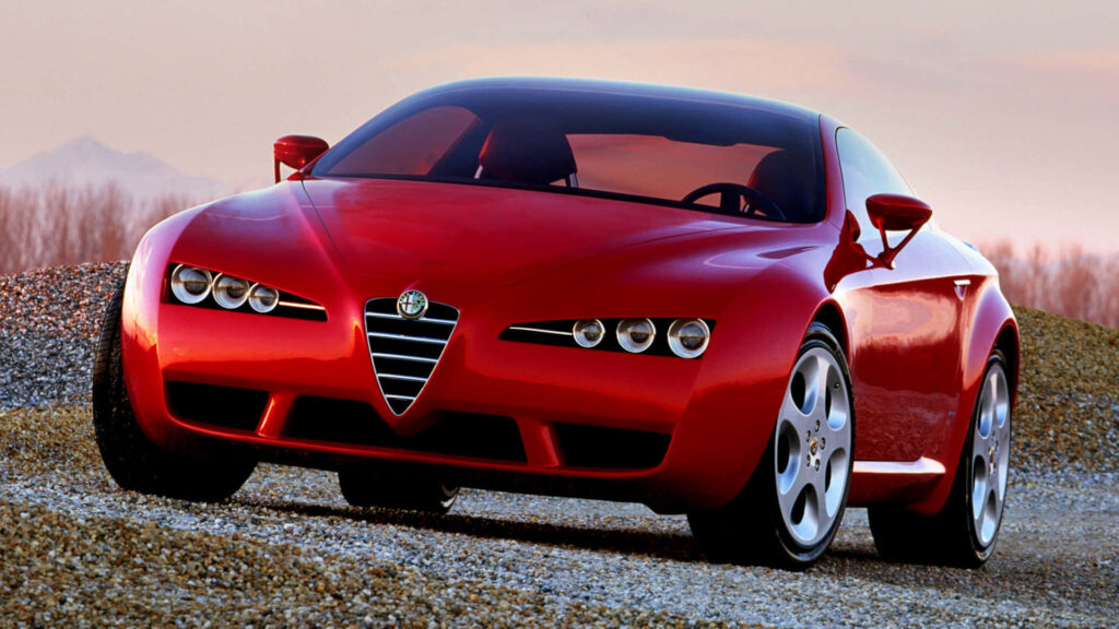 Alfa Romeo Brera red sports car sleek design on open road scenic outdoor wallpaper background