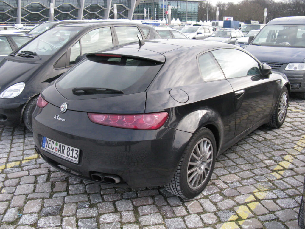 Alfa Romeo Brera black sleek sporty car parked on cobblestone lot modern curves wallpaper