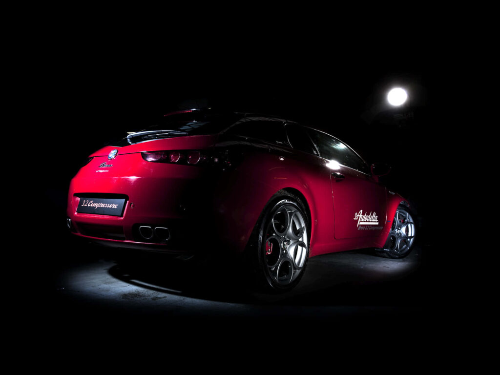 Alfa Romeo Brera sleek car illuminated against dark background automotive wallpaper design