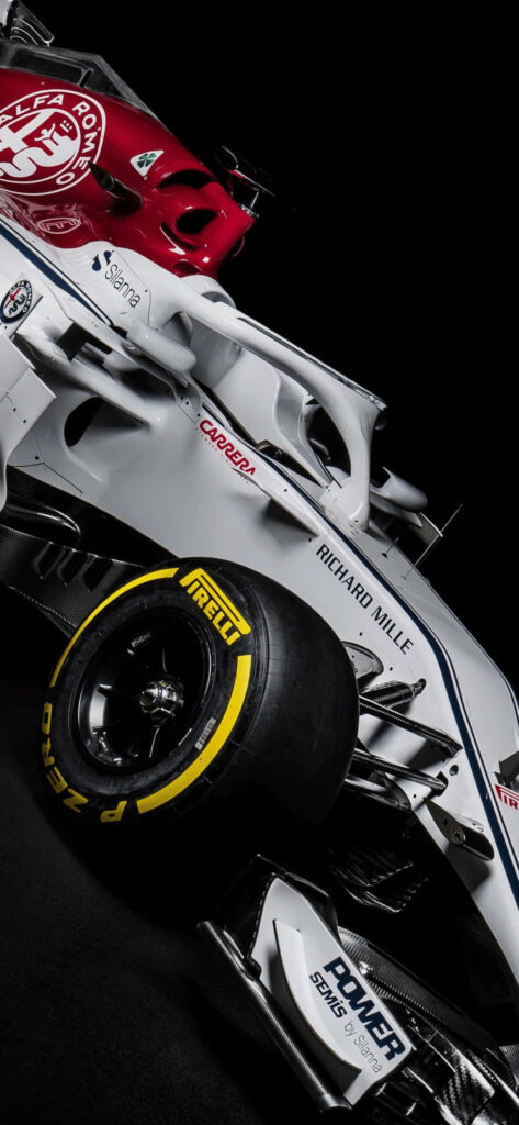 Close-up of 2018 Alfa Romeo F1 car red white aerodynamic design on sleek black background wallpaper